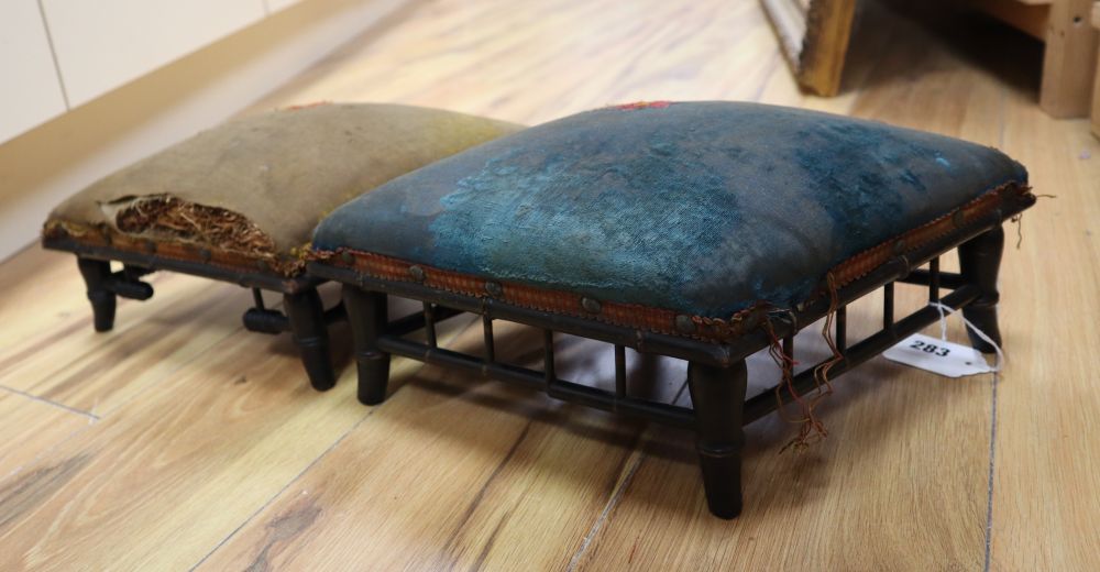 A pair of ebonised and upholstered footstools, lozenge shape, 40cm approx.